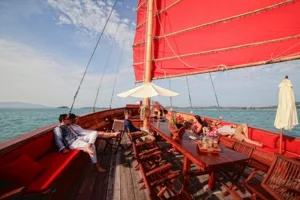 red sails up on the traditional sailing junk the red baron near koh samui