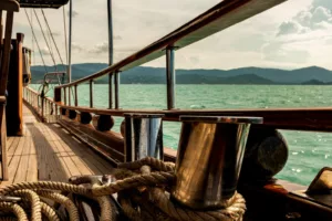 early morning light on the wooden deck of the naga sailing yacht, koh samui