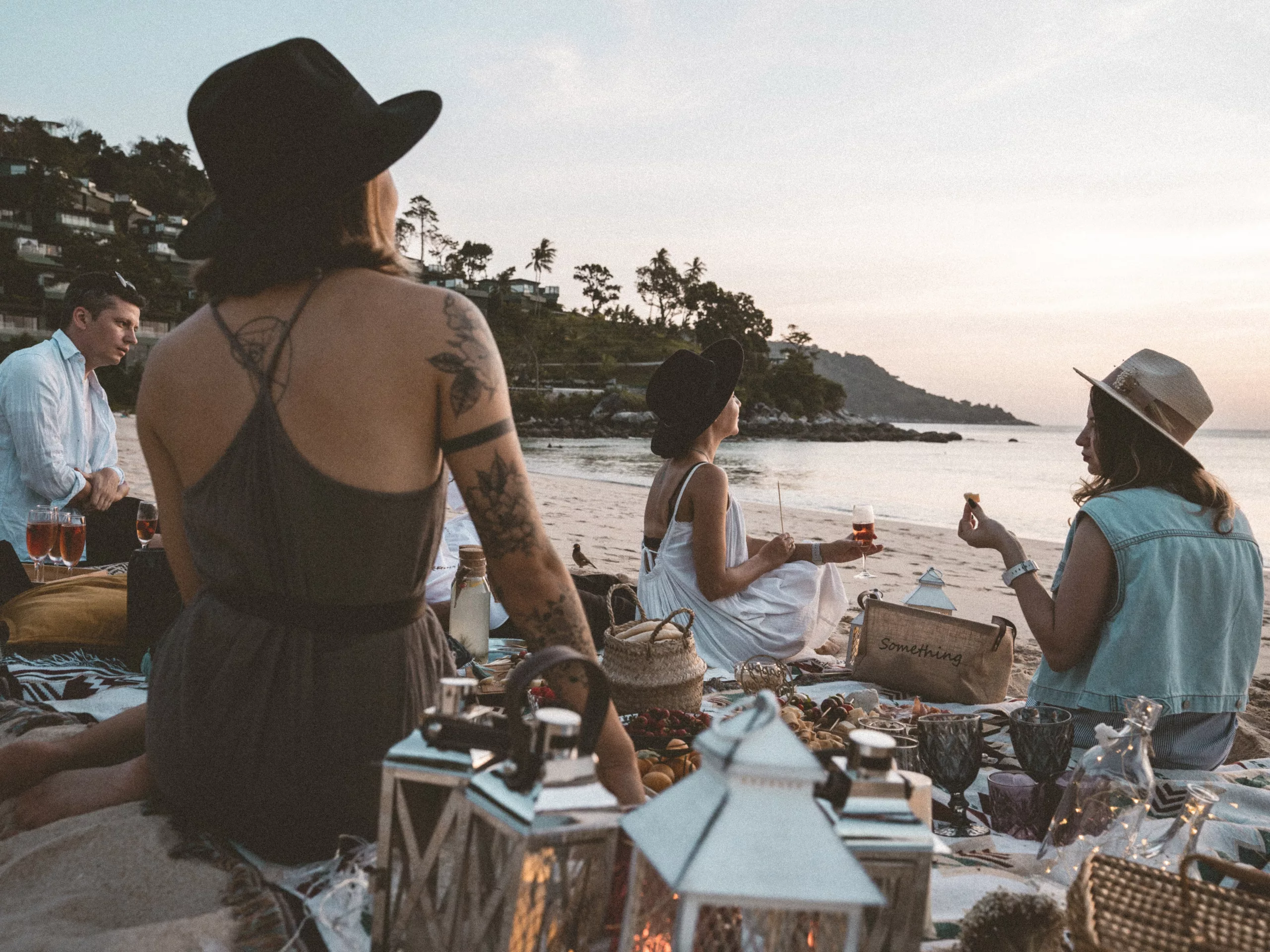 image showing a group of people having a picnic on the beach near koh samui, thailand