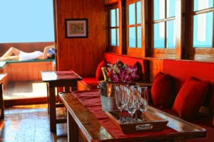 champagne in the cool lounge below the deck of the red baron samui wooden sailing junk