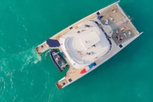 drone shot of samui best party boat at sea with people sunbathing on deck