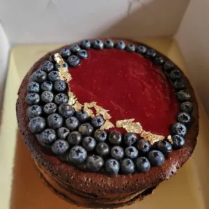 image showing red velvet cake with blueberries and edible gold leaf for luxury birthday celebration charter on samui