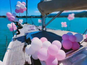 white and pink balloons on board a sailing yacht for birthday celebration