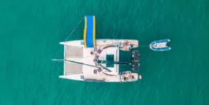 image showing aerial view of a family friendly slider catamaran charter koh samui thailand towing the tender